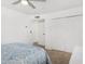 A bright bedroom with a ceiling fan, carpet, closet, and ensuite at 37414 N 17Th Ave, Phoenix, AZ 85086