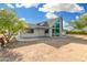 Home featuring a unique stonework entryway and large picture windows under a blue sky at 37414 N 17Th Ave, Phoenix, AZ 85086