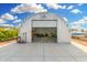 A sizable open-door garage with durable concrete flooring, ample space, and natural light, ready for vehicles and storage at 37414 N 17Th Ave, Phoenix, AZ 85086