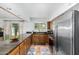 Open kitchen with long granite countertop, stainless steel refrigerator, and access to outdoor area at 37414 N 17Th Ave, Phoenix, AZ 85086