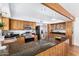 Updated kitchen with wood cabinets, granite countertops, stainless steel appliances, and breakfast bar at 37414 N 17Th Ave, Phoenix, AZ 85086