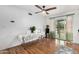 Bright living room with wood floors, ceiling fan, and sliding glass doors leading to the outdoor space at 37414 N 17Th Ave, Phoenix, AZ 85086