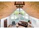 Open living space with hardwood floors, beamed ceilings and view of the backyard through large windows at 37414 N 17Th Ave, Phoenix, AZ 85086