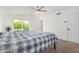 Bright main bedroom with ceiling fan, access to balcony, and neutral carpet at 37414 N 17Th Ave, Phoenix, AZ 85086