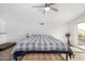 Light-filled main bedroom with ceiling fan, carpeted floor, and access to balcony at 37414 N 17Th Ave, Phoenix, AZ 85086