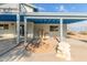 Charming outdoor patio with a blue painted ceiling, complemented by stucco columns and a unique lizard statue at 37414 N 17Th Ave, Phoenix, AZ 85086