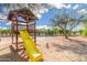 Outdoor playground structure with a yellow slide and wooden platform, promising endless fun and adventure for children at 37414 N 17Th Ave, Phoenix, AZ 85086