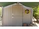 Charming shed with barn-style door and sunflower wreath detail adding rustic appeal at 37414 N 17Th Ave, Phoenix, AZ 85086