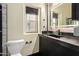 Modern bathroom featuring a sleek black vanity, toilet and a window allowing natural light at 387 N 2Nd Ave # F2, Phoenix, AZ 85003