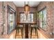 Charming dining area featuring exposed brick walls, hardwood floors, and natural light at 387 N 2Nd Ave # F2, Phoenix, AZ 85003