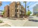 Apartment complex has residential units with stucco finish and private patios in an urban area at 387 N 2Nd Ave # F2, Phoenix, AZ 85003