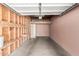 Clean, unfinished garage space with exposed wood beams, concrete floor, ladder to loft space, and ample storage at 387 N 2Nd Ave # F2, Phoenix, AZ 85003