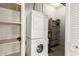 Functional laundry room with stacked washer and dryer, shelving, and ample storage space at 387 N 2Nd Ave # F2, Phoenix, AZ 85003