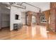 Inviting living room with hardwood floors, exposed brick, and a sleek entertainment center at 387 N 2Nd Ave # F2, Phoenix, AZ 85003