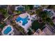 Stunning aerial view of backyard with pool, water slide, spa, waterfall, cabana, fireplace, seating, trampoline and lush landscaping at 4281 S Iowa St, Chandler, AZ 85248