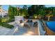 Backyard with an outdoor fireplace, seating area, mature landscaping, and a trampoline at 4281 S Iowa St, Chandler, AZ 85248