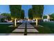Beautiful backyard has a stone pathway through lush green lawns to an outdoor pool and kitchen at 4281 S Iowa St, Chandler, AZ 85248