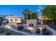 Beautiful backyard featuring a fireplace, pool, spa, and well-maintained landscaping for outdoor enjoyment at 4281 S Iowa St, Chandler, AZ 85248