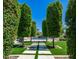 Lush backyard with manicured greenery, a stone walkway, and a glimpse of the pool area at 4281 S Iowa St, Chandler, AZ 85248
