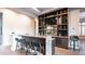 Modern home bar featuring granite countertops, dark wood accents, and a full display of liquor at 4281 S Iowa St, Chandler, AZ 85248