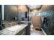 Modern bathroom featuring stylish vanity, textured wall, and glass-enclosed shower at 4281 S Iowa St, Chandler, AZ 85248