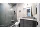 Modern bathroom with a glass-enclosed shower, gray vanity, and stylish fixtures at 4281 S Iowa St, Chandler, AZ 85248