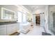 Beautiful primary bath with soaking tub, walk-in shower, double vanities, and walk-in closet access at 4281 S Iowa St, Chandler, AZ 85248