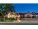 Charming home exterior with a well-manicured lawn, brick driveway, and three-car garage at dusk at 4281 S Iowa St, Chandler, AZ 85248