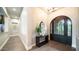 Inviting foyer featuring a dark wooden door, hardwood floors, and designer finishes at 4281 S Iowa St, Chandler, AZ 85248