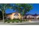 Charming single-Gathering home featuring manicured lawn, professional landscaping, and warm exterior lighting at 4281 S Iowa St, Chandler, AZ 85248