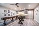 Spacious game room featuring a shuffleboard table, foosball table, wet bar, and sleek ceiling fan at 4281 S Iowa St, Chandler, AZ 85248