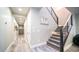 Hallway with stairs, gray wood floors, and access to a finished basement at 4281 S Iowa St, Chandler, AZ 85248