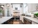 Close-up of kitchen details featuring stainless appliances, designer backsplash, and white farmhouse sink at 4281 S Iowa St, Chandler, AZ 85248
