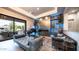 Elegant living room featuring a fireplace, piano, modern decor, and access to the backyard at 4281 S Iowa St, Chandler, AZ 85248