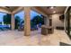 Covered patio features travertine flooring, comfortable seating, and outdoor grilling area with access to the pool at 4281 S Iowa St, Chandler, AZ 85248