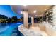 Outdoor bar overlooking custom pool featuring a swim-up bar, grotto, water slide, and multiple water features at 4281 S Iowa St, Chandler, AZ 85248