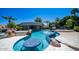Luxurious pool with swim-up bar, in-pool seating, and rock features for ultimate outdoor entertaining at 4281 S Iowa St, Chandler, AZ 85248