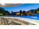 Resort-style pool and lounge area featuring a swim-up bar, waterfalls, lush landscaping, and outdoor seating at 4281 S Iowa St, Chandler, AZ 85248