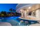 Outdoor bar with seating in the pool, as well as integrated lighting and a rock waterfall at 4281 S Iowa St, Chandler, AZ 85248