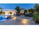 Luxury outdoor pool area featuring a modern bar, lounge chairs, and beautiful landscaping under a twilight sky at 4281 S Iowa St, Chandler, AZ 85248