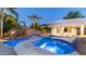 Luxurious pool area with a rock waterfall, and swim-up bar, perfect for entertaining and enjoying the outdoors at 4281 S Iowa St, Chandler, AZ 85248