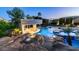 Stunning backyard pool with a swim-up bar, rock features, and well-manicured landscaping for luxurious outdoor living at 4281 S Iowa St, Chandler, AZ 85248