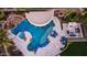 Aerial view of a custom pool with grotto, swim-up bar, water slide, and poolside fireplace and seating at 4281 S Iowa St, Chandler, AZ 85248