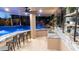 Entertaining poolside bar and cooking space with tiled flooring and view of the waterfall at 4281 S Iowa St, Chandler, AZ 85248