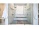 Elegant walk-in shower featuring marble tile, dual shower heads, and a comfortable seating area at 4281 S Iowa St, Chandler, AZ 85248