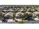 A high angle view showcases a well-maintained residential neighborhood with mature trees and varied rooflines at 43283 W Hillman Dr, Maricopa, AZ 85138