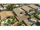 An aerial view of several homes showcasing their private pools, desert landscaping, and proximity to each other at 43283 W Hillman Dr, Maricopa, AZ 85138