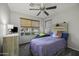 Bright bedroom featuring a ceiling fan, a cozy beanbag chair, and a decorative unicorn pillow on a twin bed at 43283 W Hillman Dr, Maricopa, AZ 85138