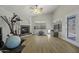 Spacious bonus room with wood floors, fireplace, lots of natural light, and high ceilings at 43283 W Hillman Dr, Maricopa, AZ 85138