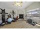 Bonus room with a vaulted ceiling, fireplace, and lots of workout equipment at 43283 W Hillman Dr, Maricopa, AZ 85138